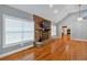 Bright living room featuring a stone fireplace, large windows, and hardwood floors at 4332 Brushy Mountain Rd, Rockmart, GA 30153