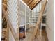 Attic interior featuring built-in shelving and ladder, providing ample storage space at 979 Bridgegate Ne Dr, Marietta, GA 30068