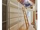 Attic interior featuring built-in shelving and ladder, offering ample storage solutions at 979 Bridgegate Ne Dr, Marietta, GA 30068