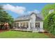 A backyard featuring a patio, lawn, mature trees, and a well-maintained garden at 979 Bridgegate Ne Dr, Marietta, GA 30068