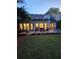 Exterior of home featuring a stone patio, lush green lawn, and outdoor seating area, creating a relaxing retreat at 979 Bridgegate Ne Dr, Marietta, GA 30068