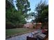 Backyard view featuring a stone patio, lush green lawn, and privacy fence, perfect for outdoor entertaining at 979 Bridgegate Ne Dr, Marietta, GA 30068
