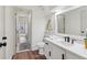 Bright bathroom with a white vanity, black hardware, and wood-look floors at 979 Bridgegate Ne Dr, Marietta, GA 30068