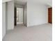 Large bonus room with neutral carpet, a built-in bookshelf, and many entry doors at 979 Bridgegate Ne Dr, Marietta, GA 30068