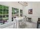 Bright dining area with white table, chairs, and large windows overlooking the backyard at 979 Bridgegate Ne Dr, Marietta, GA 30068