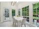 Bright dining area with white table, chairs, and large windows overlooking the backyard at 979 Bridgegate Ne Dr, Marietta, GA 30068