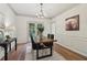 Dining room with chandelier, wainscoting, and french doors leading to patio at 979 Bridgegate Ne Dr, Marietta, GA 30068