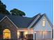 Charming home exterior at twilight with stone accents and a two-car garage, creating a welcoming ambiance at 979 Bridgegate Ne Dr, Marietta, GA 30068