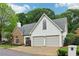 Charming home exterior showcasing stone accents, a well-kept lawn, and a two-car garage for convenient parking at 979 Bridgegate Ne Dr, Marietta, GA 30068