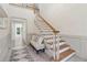 Bright foyer featuring staircase with oak handrail and bench seating at 979 Bridgegate Ne Dr, Marietta, GA 30068