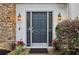 Inviting front door with decorative sidelights, stone accents, and blooming flowers at 979 Bridgegate Ne Dr, Marietta, GA 30068
