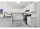 Bright kitchen with white cabinets, stainless steel appliances, and black fixtures at 979 Bridgegate Ne Dr, Marietta, GA 30068