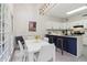 Eat-in kitchen featuring white cabinets, a breakfast bar, and abundant natural light from large windows at 979 Bridgegate Ne Dr, Marietta, GA 30068