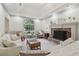 Bright living room featuring a stone fireplace, tray ceiling, and hardwood floors at 979 Bridgegate Ne Dr, Marietta, GA 30068
