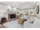 Spacious living room featuring a stone fireplace, tray ceiling, and hardwood floors at 979 Bridgegate Ne Dr, Marietta, GA 30068