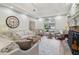 Bright living room featuring a stone fireplace, tray ceiling, and large arched window at 979 Bridgegate Ne Dr, Marietta, GA 30068