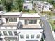 A high-angle view showcases rooftop patios on modern townhomes, with a street and other townhomes visible in the background at 2171 Burnside Dr Nw, Atlanta, GA 30318