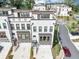 View of modern townhomes, with attached one car garages, and manicured lawns at 2171 Burnside Dr Nw, Atlanta, GA 30318