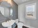 Stylish powder room features modern fixtures and a sleek design with a round mirror at 2171 Burnside Dr Nw, Atlanta, GA 30318