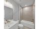 Bright bathroom features a bathtub and a shower with a tile surround at 2171 Burnside Dr Nw, Atlanta, GA 30318