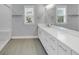 Bright bathroom features a double sink vanity, sleek fixtures, and glass-enclosed shower at 2171 Burnside Dr Nw, Atlanta, GA 30318
