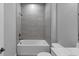 Modern bathroom featuring a tub with gray-tiled walls and contemporary fixtures at 2171 Burnside Dr Nw, Atlanta, GA 30318