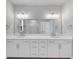 A bright bathroom showcases an extended double sink vanity, large mirror, and modern fixtures at 2171 Burnside Dr Nw, Atlanta, GA 30318