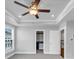 Open bedroom shows a tray ceiling with fan, recessed lights, walk in closet, and window at 2171 Burnside Dr Nw, Atlanta, GA 30318