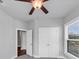 Bedroom featuring a wooden ceiling fan, double closets, and a window overlooking the outdoors at 2171 Burnside Dr Nw, Atlanta, GA 30318