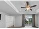 Spacious bedroom featuring a tray ceiling with ceiling fan and a sliding door to the balcony at 2171 Burnside Dr Nw, Atlanta, GA 30318