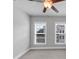 Bedroom features neutral walls, carpet, ceiling fan, and two windows for natural light at 2171 Burnside Dr Nw, Atlanta, GA 30318