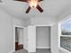 Bright bedroom featuring a ceiling fan, closet, and window at 2171 Burnside Dr Nw, Atlanta, GA 30318