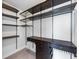 A spacious walk-in closet is well organized with custom shelving and dark wood cabinets at 2171 Burnside Dr Nw, Atlanta, GA 30318