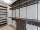 Walk-in closet is well organized with custom shelving, dark wood cabinets, and ample storage at 2171 Burnside Dr Nw, Atlanta, GA 30318