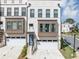 Modern townhome with a white brick facade, bay windows, and a one car garage at 2171 Burnside Dr Nw, Atlanta, GA 30318