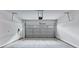 A well-lit, spacious garage featuring a smooth concrete floor and modern, automatic door system at 2171 Burnside Dr Nw, Atlanta, GA 30318