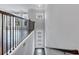 Hallway of a home, with hardwood floors, and a staircase with black iron railings at 2171 Burnside Dr Nw, Atlanta, GA 30318