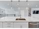 Kitchen island with quartz countertop, stainless steel sink, and modern fixtures at 2171 Burnside Dr Nw, Atlanta, GA 30318