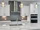 Modern kitchen showcasing granite counters, gray subway tile, and stainless steel appliances at 2171 Burnside Dr Nw, Atlanta, GA 30318