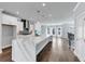 Bright open kitchen featuring an oversized island, stainless appliances, and hardwood floors at 2171 Burnside Dr Nw, Atlanta, GA 30318