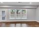 Bright living room with hardwood floors, three large windows, and neutral paint at 2171 Burnside Dr Nw, Atlanta, GA 30318