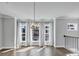 Bright living area with hardwood floors, large windows, and elegant chandelier at 2171 Burnside Dr Nw, Atlanta, GA 30318