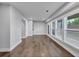 Spacious living room with hardwood floors, neutral walls, large windows, and an exterior door at 2171 Burnside Dr Nw, Atlanta, GA 30318