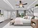 Comfortable main bedroom boasts a tray ceiling with fan, balcony access, and stylish furnishings at 2171 Burnside Dr Nw, Atlanta, GA 30318