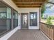 Outdoor porch space with wood flooring and trim, offering a view of the surrounding neighborhood at 2171 Burnside Dr Nw, Atlanta, GA 30318