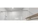 The modern shower has glass doors, vertical white tiles, and sleek fixtures at 2171 Burnside Dr Nw, Atlanta, GA 30318