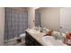 Bathroom with a double sink vanity, a shower with a curtain, and neutral wall colors at 2631 Lovejoy Crossing Dr, Hampton, GA 30228