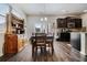 Dining area with dark hardwood floors, large windows, and wooden furniture at 2631 Lovejoy Crossing Dr, Hampton, GA 30228