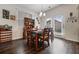 Bright dining room featuring hardwood floors, large windows, and a rustic dining set at 2631 Lovejoy Crossing Dr, Hampton, GA 30228