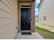 Close-up of the home's front door entrance, with tan siding and brick trim at 2631 Lovejoy Crossing Dr, Hampton, GA 30228